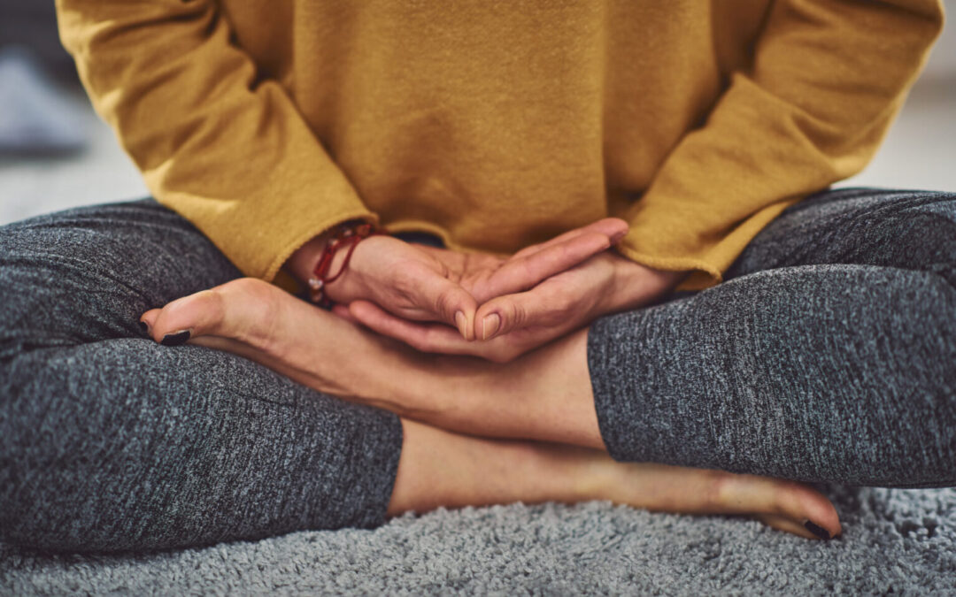 Close up of caucasian woman meditating indoors.